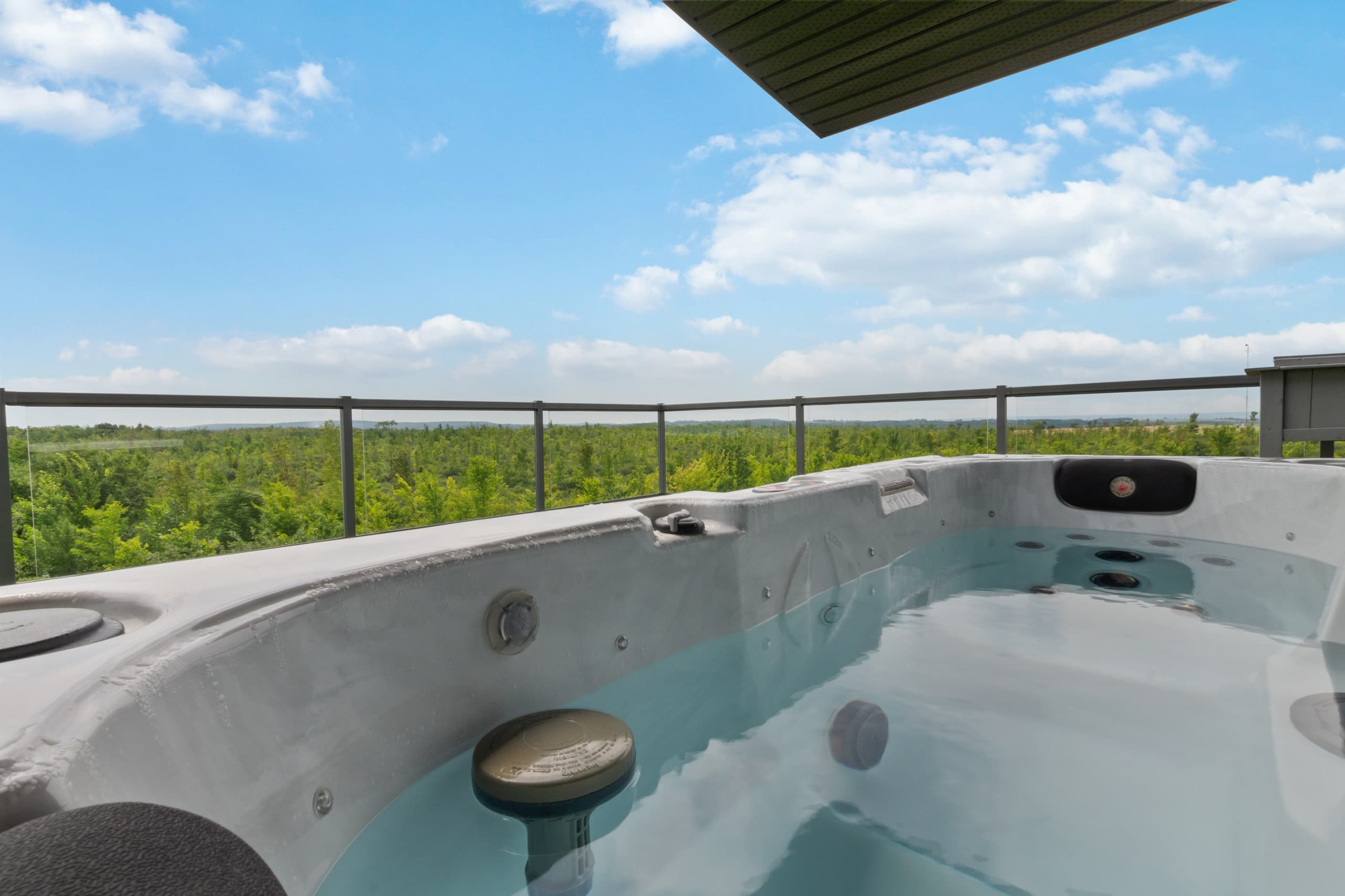 Close view of the rooftop hot tub filled and steaming under an open sky