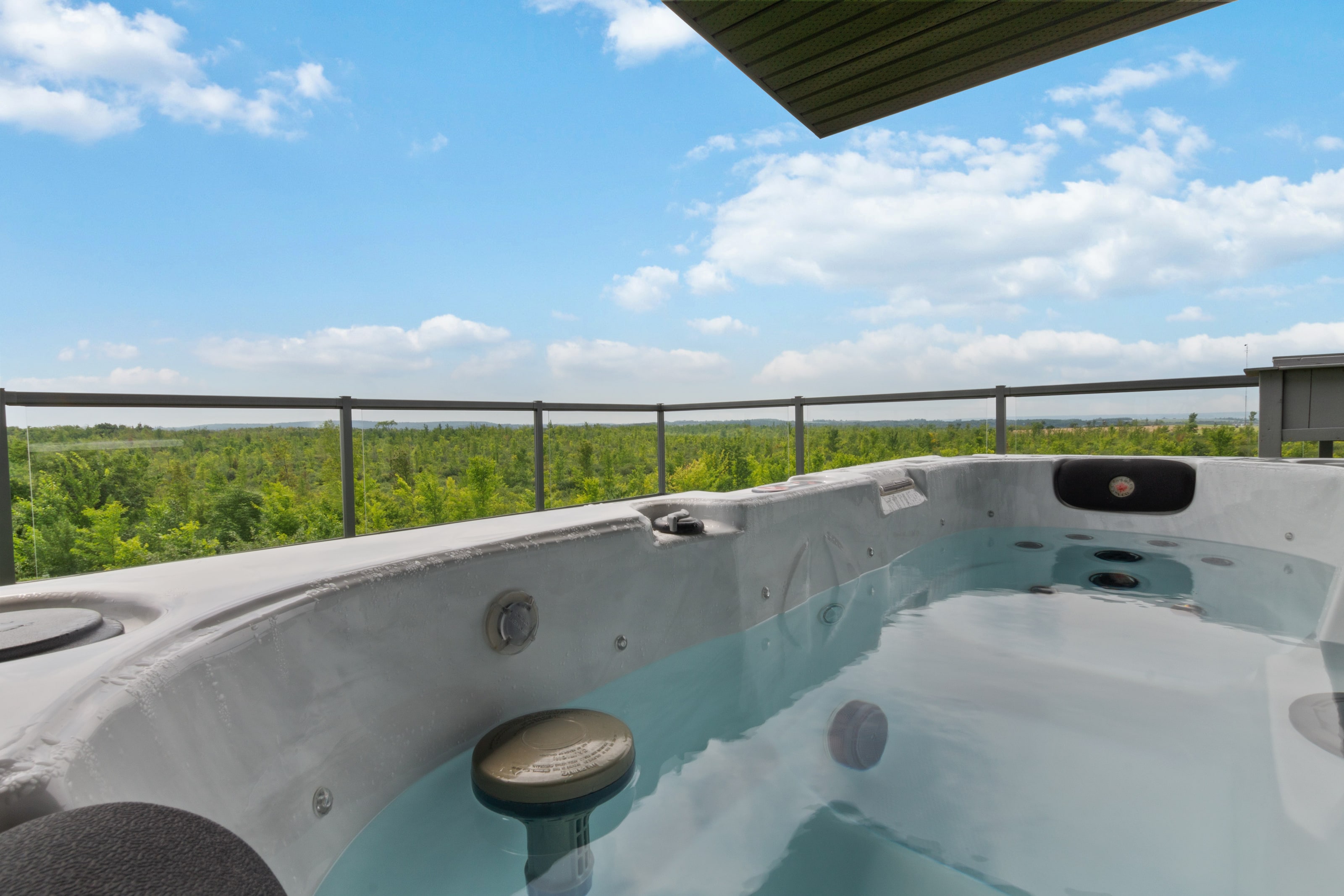 Close view of the rooftop hot tub filled and steaming under an open sky